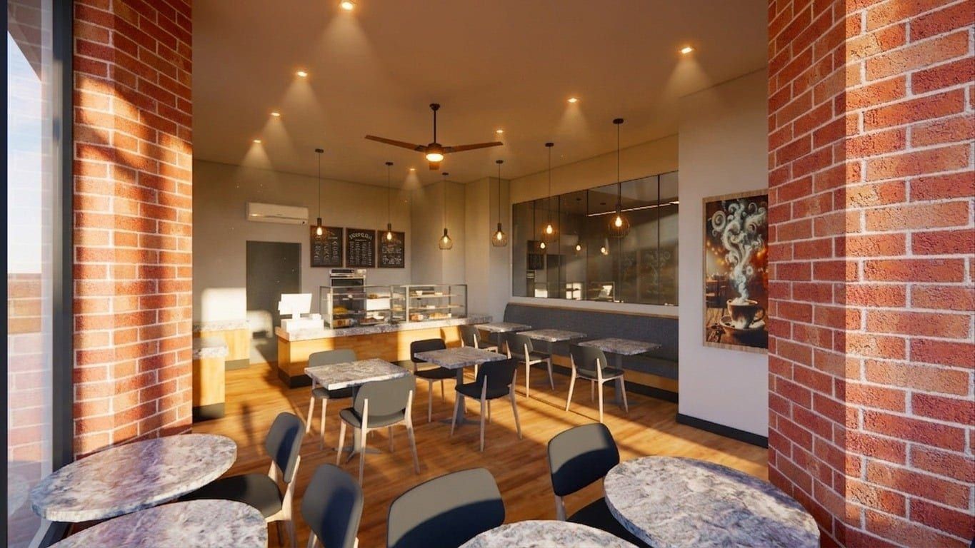 Exposed-brick café and bakery interior, wide view toward the counter